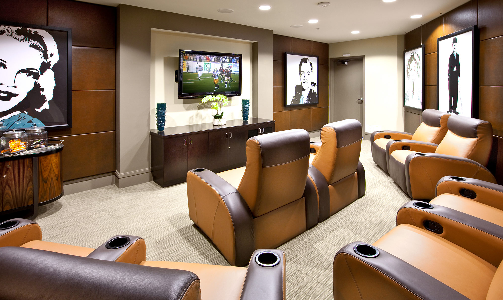 Theatre room with reclining leather chairs and television