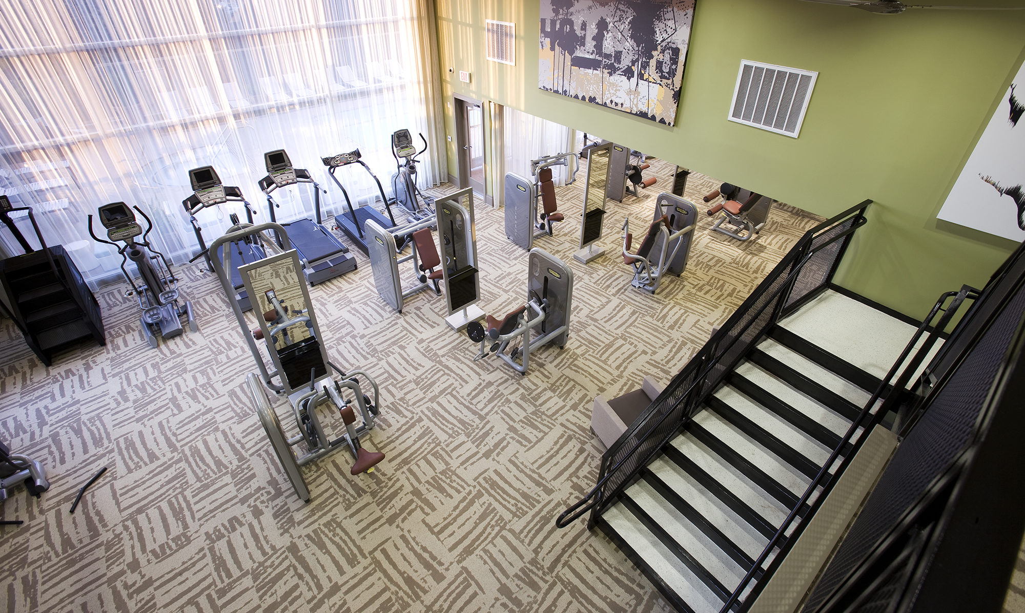 Gym from an ariel view with green walls and tan floor