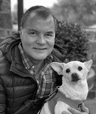 Headshot of Tom Greer with his dog